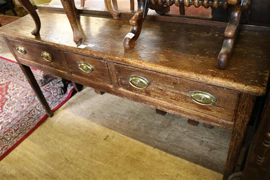 A late 18th century oak three drawer dresser, on square tapered legs